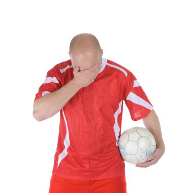 Upset soccer player in the red form. clipart