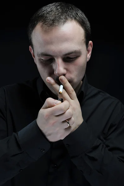 Young man smokes a cigarette — Stock Photo, Image