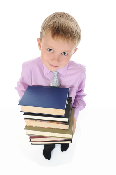 Çocuk bir kitap yığını tutan — Stok fotoğraf