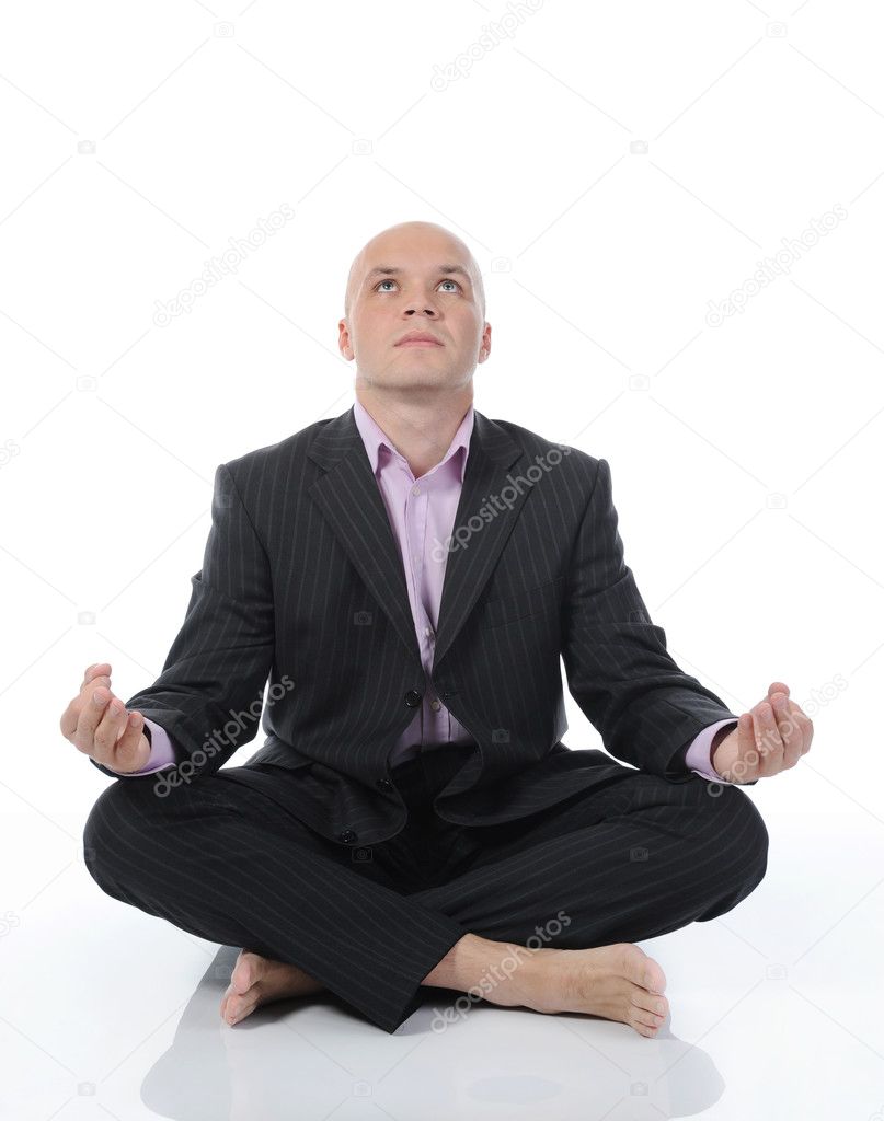 Businessman meditating in yoga lotus