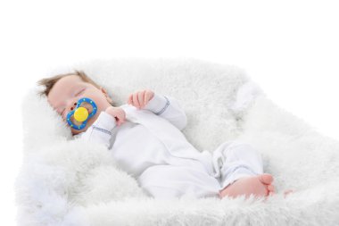 Baby sleeps with a pacifier in her mouth. Isolated on white background clipart