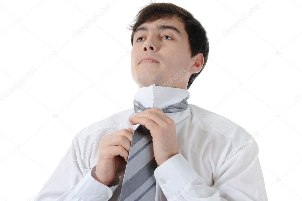 Businessman tying his tie. Isolated on white background