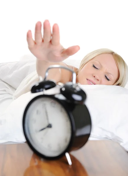 Sleepy woman turns off the alarm — Stock Photo, Image