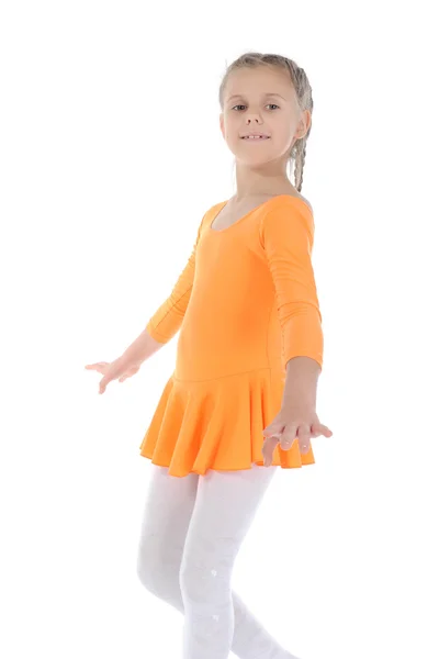 Beautiful ballerina dancing in an orange dress. — Stock Photo, Image