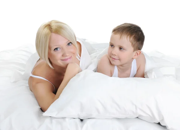 Happy family lying in bed — Stock Photo, Image