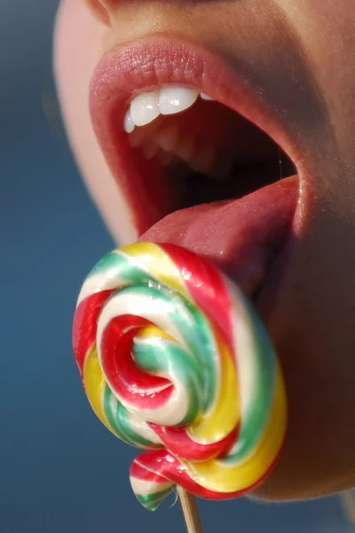 stock image Woman licking a spiral lollipop