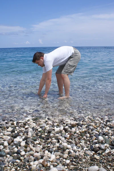 stock image Man washing his hands in the sea