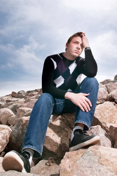 Young man on the rocks — Stock Photo, Image