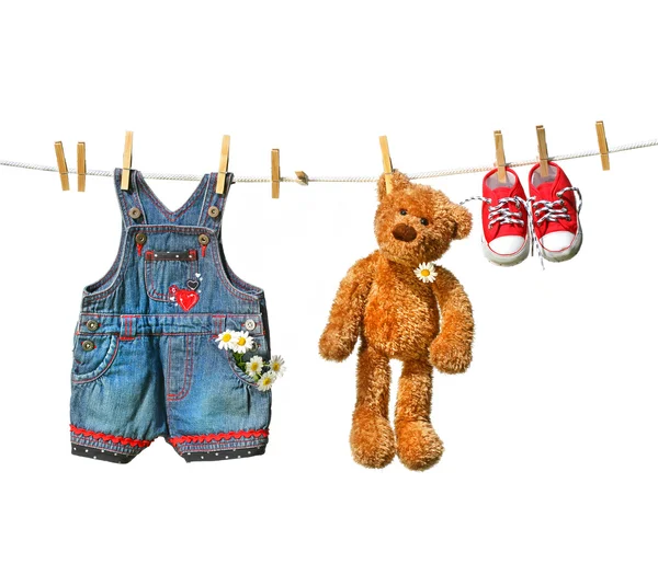 Clothes with teddy bear on clothesline — Stock Photo, Image