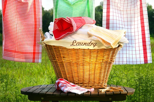 Laundry basket on rustic table Stock Photo