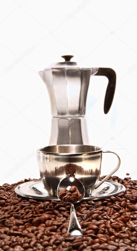 Cups resting on coffee beans with percolator