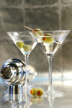 Martinis with green olives on bar counter clipart