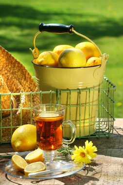 Early morning lemon tea in the garden clipart