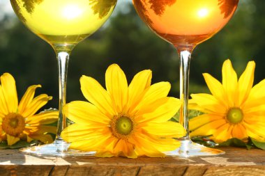 Golden wine in the sun on a rustic table clipart