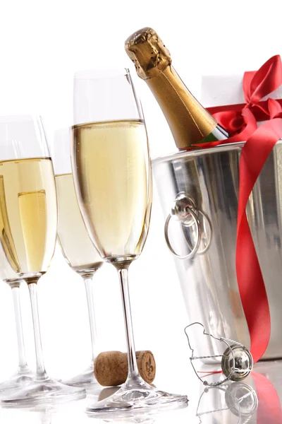 Очки с шампанским в ведре со льдом и подарок — стоковое фото
