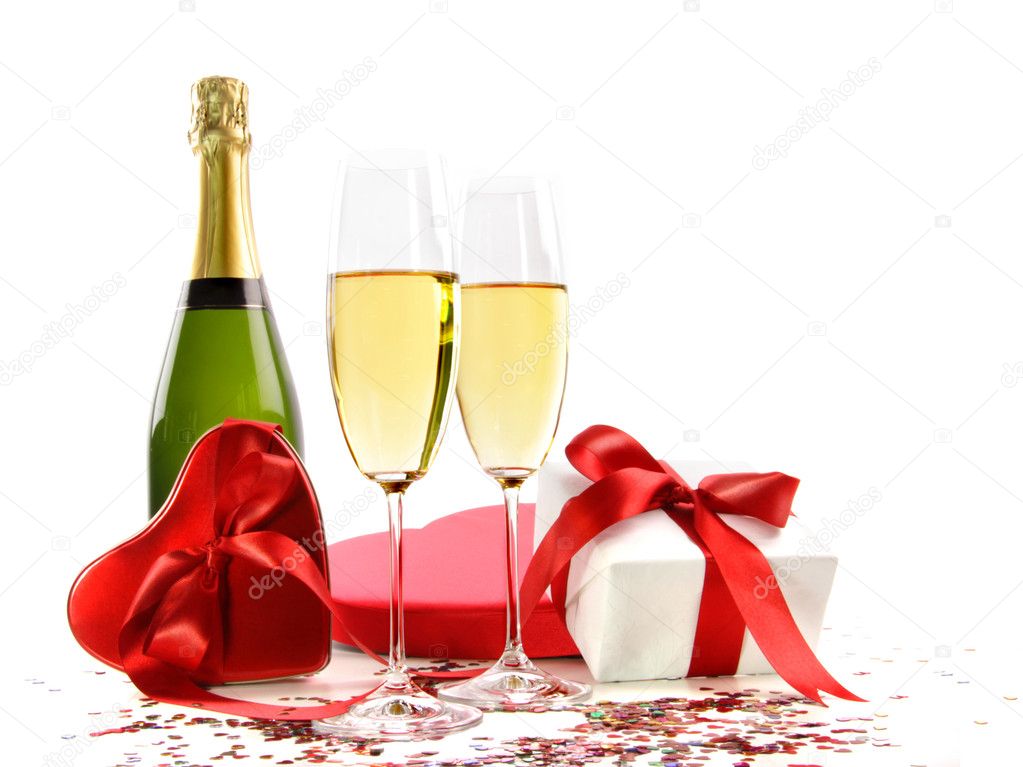 Glasses of champagne with bottle and gifts
