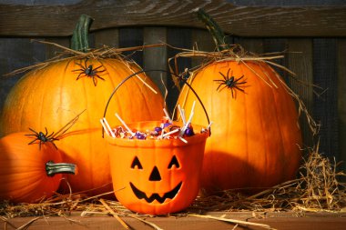 Bucket filled with halloween candy clipart