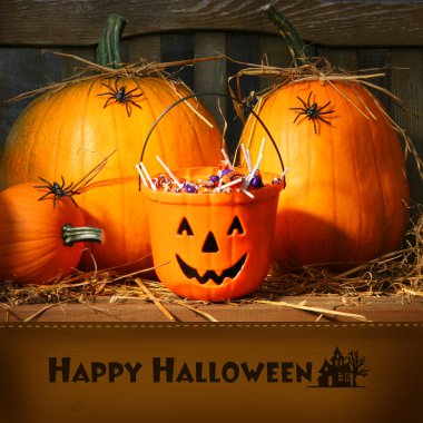 Bucket filled with halloween candy clipart