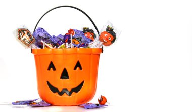 Jack-o-Lantern bucket filled with candies on white clipart