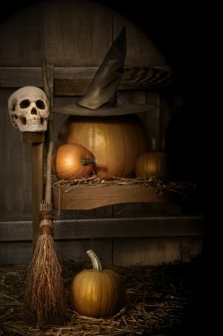 Big pumpkin with black witch hat and broom clipart