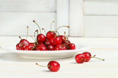 Cherries on a white plate clipart