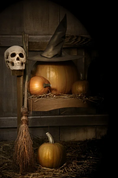 Big pumpkin with black witch hat and broom — Stock Photo, Image
