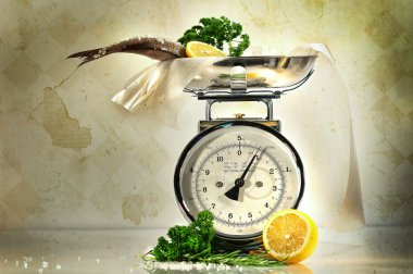 Weight scale with fish and lemons clipart