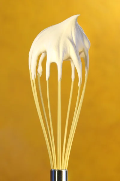 Whisk with whip cream on top — Stock Photo, Image
