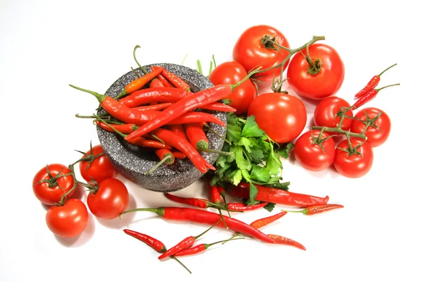 Assortment of red peppers and tomatoes on white — Stock Photo, Image