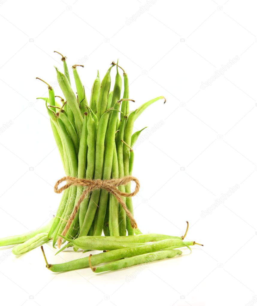 Unwashed green beans tied with cord on white