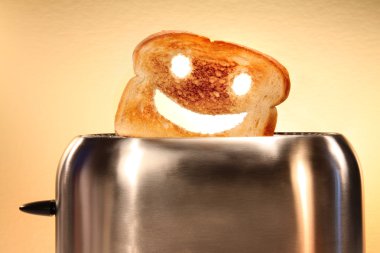 Toast with smiley face in toaster on counter clipart