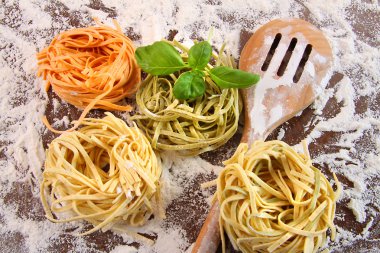 Uncooked italian pasta in three colours clipart