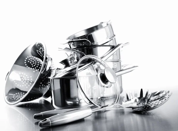 Pile of pots and pans against white — Stock Photo, Image
