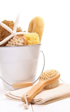 Bucket filled with sponges, scrub brushes and starfish clipart