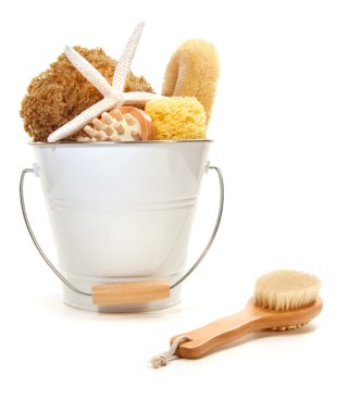 White bucket filled with sponges and scrub brushes clipart