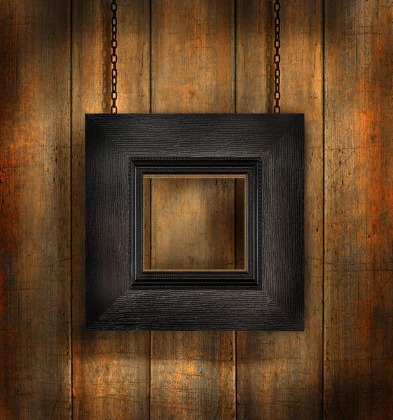 Moldura de madeira escura contra fundo de madeira — Fotografia de Stock