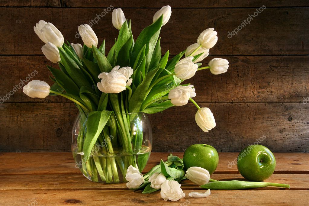 White tulips in glass vase on rustic wood Stock Photo by ...