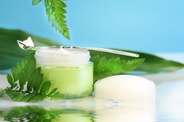 Rejuvenating face cream with ferns clipart