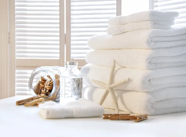 Fluffy white towels on table — Stock Photo, Image