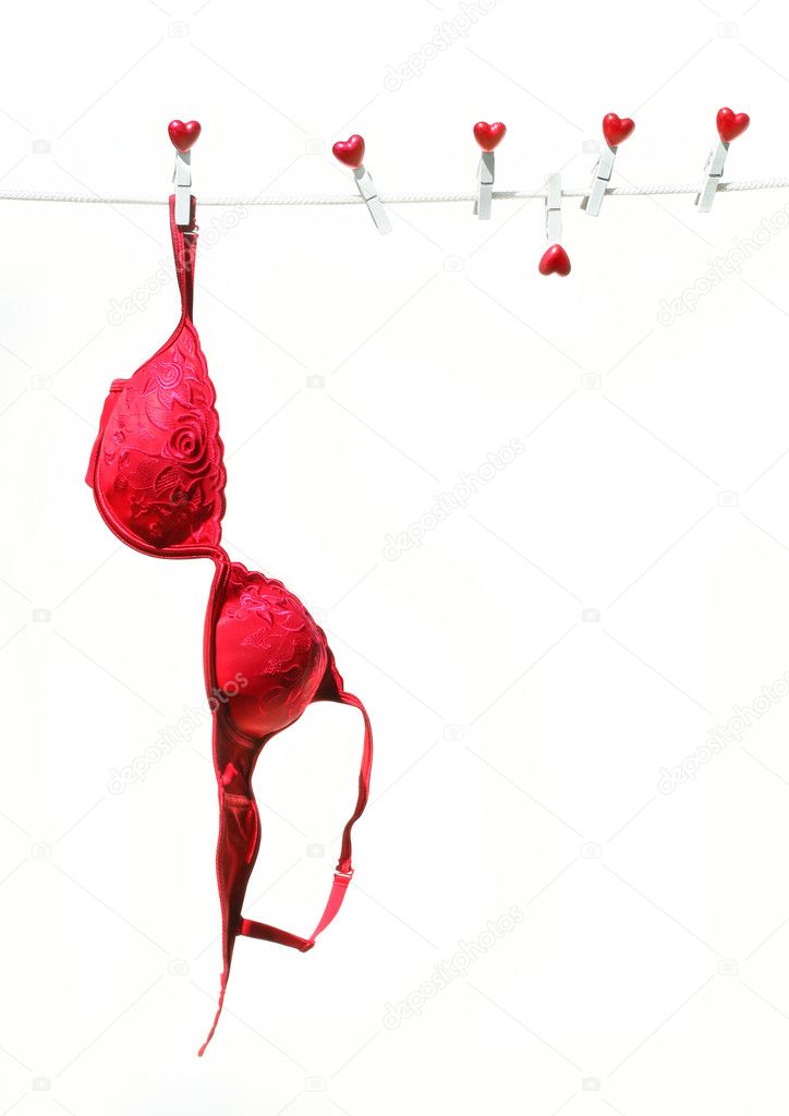Red brassierre hanging on clothesline