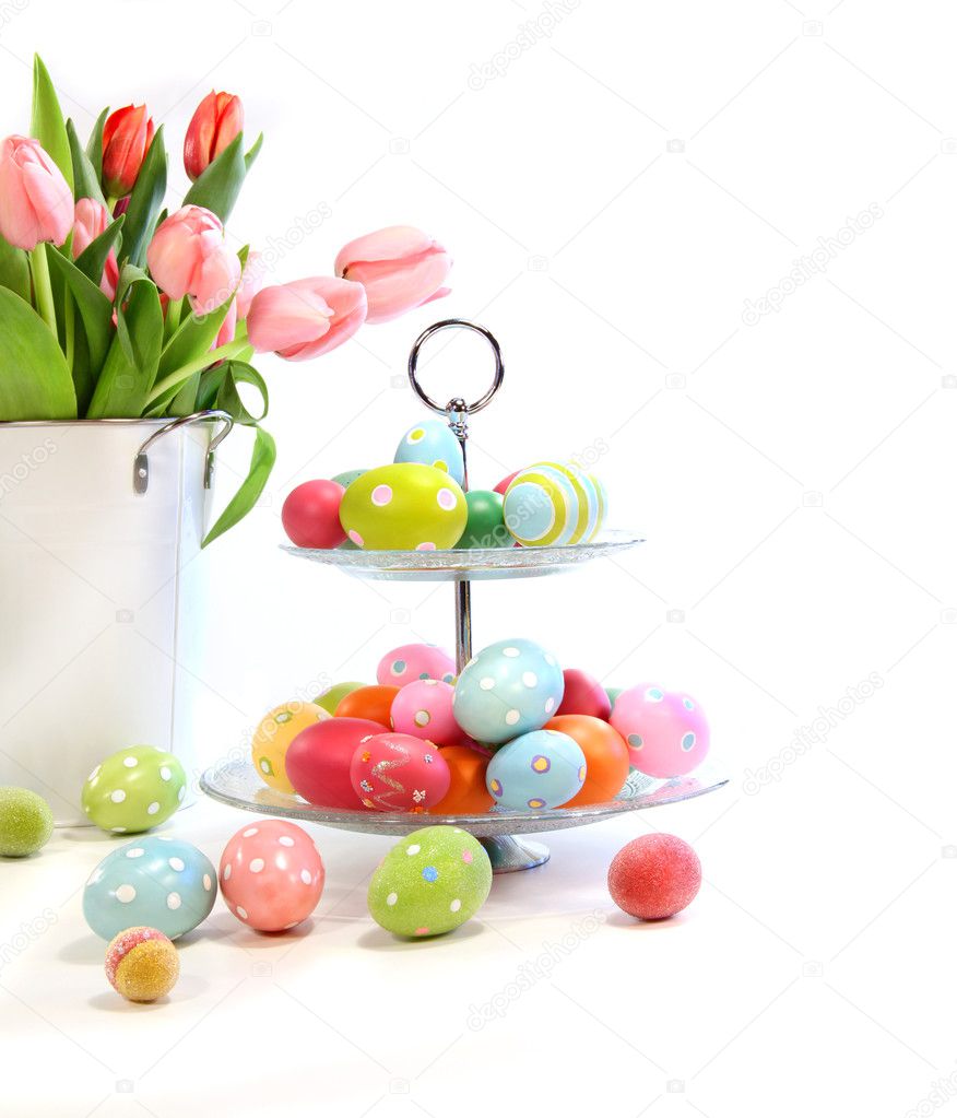 Colorful easter eggs with pink tulips on white