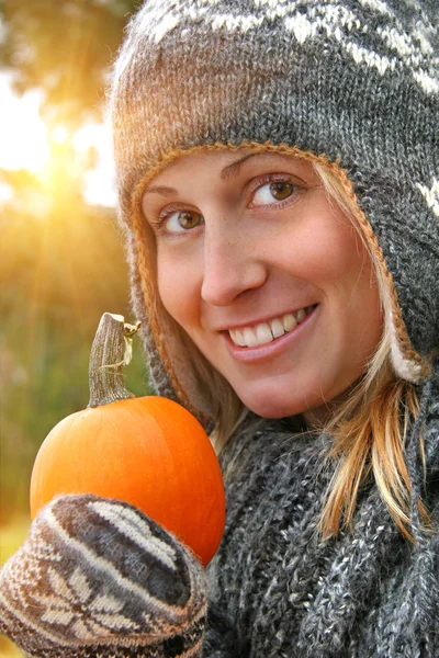 Pretty young woman holding a pumpkin — Stock Photo, Image