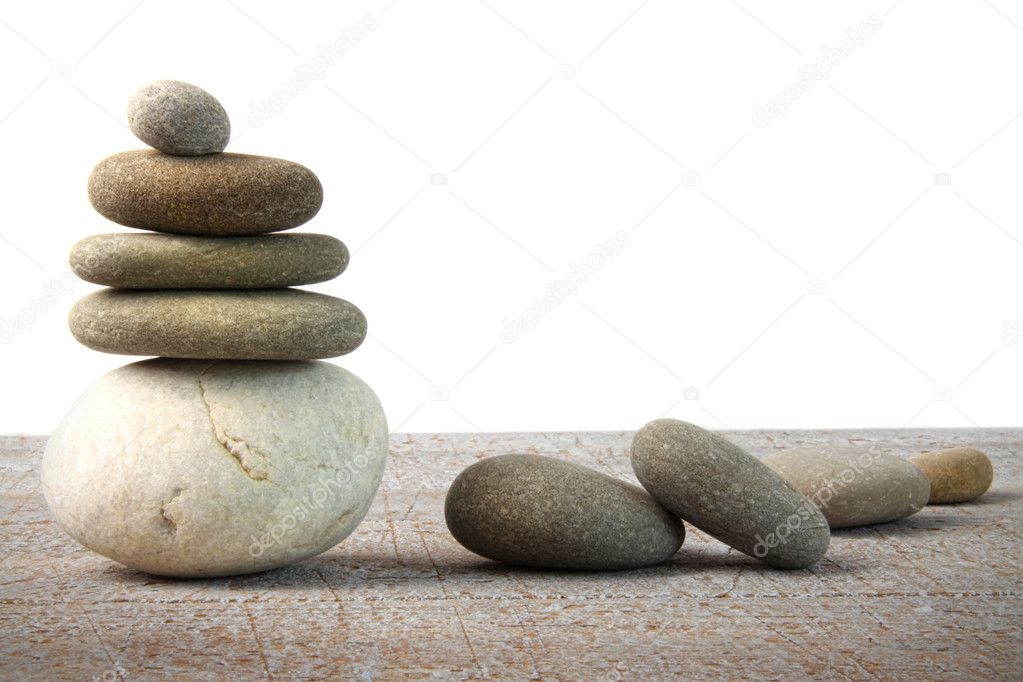Stack of spa rocks on wood on white