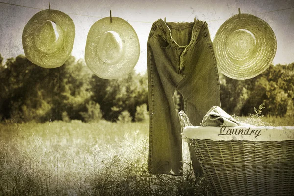 Old grunge photo of jeans and straw hats — Stock Photo, Image