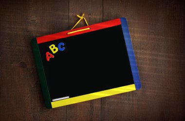 Child's chalkboard hanging against wood clipart