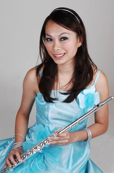 Asian girl with flute. — Stock Photo, Image