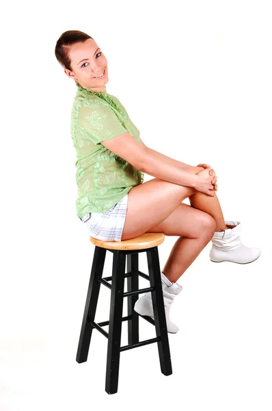 Pretty girl on a bar chair. — Stock Photo, Image