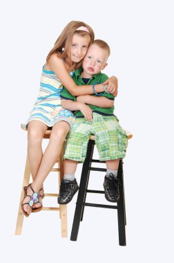 Girl giving hug to brother. clipart