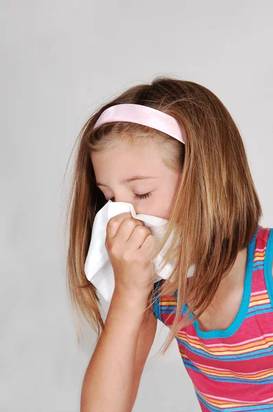 stock image Young girl sneezing.