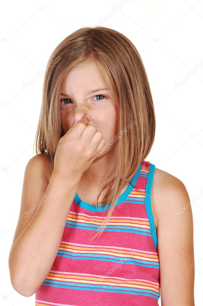 Girl holds her nose closed.